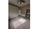 Bedroom with carpeting, open closet, and a door leading to another room at 7741 Bardmoor Hill Cir, Orlando, FL 32835