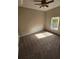 A cozy bedroom featuring neutral walls, ceiling fan, and a window offering natural light at 7741 Bardmoor Hill Cir, Orlando, FL 32835