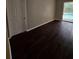 Bedroom with wood flooring and a sliding glass door leading to a screened in pool area at 7741 Bardmoor Hill Cir, Orlando, FL 32835