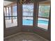 Breakfast nook features tile flooring and multiple windows showcasing the outdoor pool at 7741 Bardmoor Hill Cir, Orlando, FL 32835