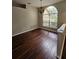 Dining room with hardwood floors, a chandelier, and a large arched window at 7741 Bardmoor Hill Cir, Orlando, FL 32835