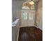 Foyer with hardwood flooring, decorative glass doors, and arched transom window at 7741 Bardmoor Hill Cir, Orlando, FL 32835