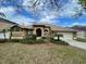 Beautiful single story home with desert landscaping, arched windows, and an attached two car garage at 7741 Bardmoor Hill Cir, Orlando, FL 32835