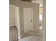 Neutral hallway features ceramic tile and access to rooms in the home at 7741 Bardmoor Hill Cir, Orlando, FL 32835