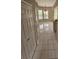 Hallway with white tile flooring, a closet, and a view of the surrounding windows at 7741 Bardmoor Hill Cir, Orlando, FL 32835