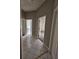 Hallway with white tile flooring, multiple doorways, and access to bathroom and bedroom areas at 7741 Bardmoor Hill Cir, Orlando, FL 32835