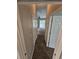 Hallway with carpeted flooring leading to a bright living area with access to the pool at 7741 Bardmoor Hill Cir, Orlando, FL 32835