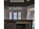 Bright kitchen features views of a screened pool area from three windows at 7741 Bardmoor Hill Cir, Orlando, FL 32835