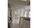 Kitchen featuring modern stainless steel appliances, white cabinets, and tile flooring at 7741 Bardmoor Hill Cir, Orlando, FL 32835
