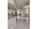Open kitchen layout features white cabinets, breakfast bar, and bright, tiled flooring at 7741 Bardmoor Hill Cir, Orlando, FL 32835