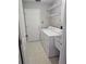 Functional laundry room with washer, dryer, storage shelves, and utility sink at 7741 Bardmoor Hill Cir, Orlando, FL 32835