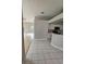 Open concept living and kitchen area with light-colored walls and tile flooring at 7741 Bardmoor Hill Cir, Orlando, FL 32835