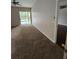 Carpeted living room with natural light at 7741 Bardmoor Hill Cir, Orlando, FL 32835