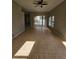 Large living area with tiled flooring and view through sliding glass doors to the pool at 7741 Bardmoor Hill Cir, Orlando, FL 32835