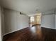 Living room with hardwood floors and ample natural light from arched windows at 7741 Bardmoor Hill Cir, Orlando, FL 32835