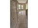Bright living space featuring tile flooring, a built in bar, and windows with views of the pool area at 7741 Bardmoor Hill Cir, Orlando, FL 32835