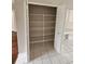 Pantry with white shelving and tile flooring, providing ample storage space at 7741 Bardmoor Hill Cir, Orlando, FL 32835