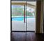 The view from inside shows a sliding door out to a screened in patio and pool at 7741 Bardmoor Hill Cir, Orlando, FL 32835