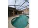 Inviting screened-in pool featuring a spa and a spacious deck area, perfect for outdoor relaxation and entertainment at 7741 Bardmoor Hill Cir, Orlando, FL 32835