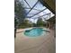 Private screened-in pool area with a hot tub and lush landscaping at 7741 Bardmoor Hill Cir, Orlando, FL 32835