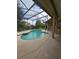 Private screened-in pool area with a hot tub and lush landscaping at 7741 Bardmoor Hill Cir, Orlando, FL 32835