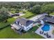 Aerial view of home showcasing the exterior, large yard, pool, and surrounding landscape at 900 W Plant St, Winter Garden, FL 34787