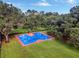 Aerial view of the outdoor basketball court surrounded by mature trees and lush green grass at 900 W Plant St, Winter Garden, FL 34787