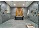 This bathroom features a soaking tub, walk-in shower with glass surround, and a wall clad in tiger-striped wood at 900 W Plant St, Winter Garden, FL 34787