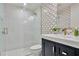 Elegant bathroom with marble vanity, sink, gold fixtures, and gold decorative tile at 900 W Plant St, Winter Garden, FL 34787