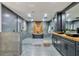 This bathroom features a modern soaking tub, walk-in shower, gray tile, and floating vanity with stylish countertop sinks at 900 W Plant St, Winter Garden, FL 34787