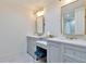 Stylish bathroom with double vanity, gold fixtures, and two mirrors at 900 W Plant St, Winter Garden, FL 34787