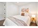 Bright bedroom featuring hardwood floors, a comfortable queen bed, and stylish wall decorations at 900 W Plant St, Winter Garden, FL 34787