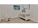 Cozy Bedroom with hardwood floors, a white rocking chair, and a white baby crib with blue accents at 900 W Plant St, Winter Garden, FL 34787