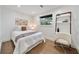 Charming bedroom features hardwood floors, a stylish desk, and a comfortable queen bed at 900 W Plant St, Winter Garden, FL 34787