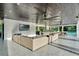 A large covered patio with outdoor seating, outdoor kitchen, and view of the pool at 900 W Plant St, Winter Garden, FL 34787
