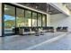 A large covered patio with outdoor seating and view of the pool at 900 W Plant St, Winter Garden, FL 34787