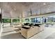 A large covered patio with outdoor seating, pool table, outdoor kitchen, and pool at 900 W Plant St, Winter Garden, FL 34787