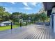 An expansive deck with cable railing, offering an outdoor seating area, and green space view at 900 W Plant St, Winter Garden, FL 34787