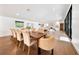 Spacious dining room with an extra long table, wood floors, and natural light, perfect for gatherings at 900 W Plant St, Winter Garden, FL 34787
