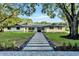 Daytime view of a single-story home with a landscaped front yard and a stone pathway leading to the front door at 900 W Plant St, Winter Garden, FL 34787