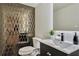 Chic half bath showcases geometric tiled accent wall and modern fixtures, vanity, and toilet at 900 W Plant St, Winter Garden, FL 34787