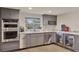 Modern kitchen features stainless steel appliances, gray cabinets and wine rack at 900 W Plant St, Winter Garden, FL 34787