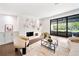 Bright, stylish living room with fireplace, neutral decor, and seamless access to outdoor living space at 900 W Plant St, Winter Garden, FL 34787
