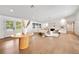 Bright living room with hardwood floors, fireplace, stylish furniture, and natural light from the garden doors at 900 W Plant St, Winter Garden, FL 34787