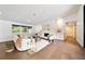Bright living room featuring a white brick fireplace, hardwood floors, and modern furnishings at 900 W Plant St, Winter Garden, FL 34787