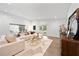The living room boasts a sectional couch, hardwood floors, and access to the pool through glass doors at 900 W Plant St, Winter Garden, FL 34787