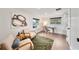 Well-lit home office space with desk, two windows, contemporary artwork, and comfortable chairs at 900 W Plant St, Winter Garden, FL 34787