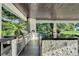 The outdoor kitchen has granite countertops, stainless steel appliances, and grill at 900 W Plant St, Winter Garden, FL 34787