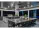 Outdoor kitchen featuring stainless steel appliances, granite countertops, bar seating, and a large dining table at 900 W Plant St, Winter Garden, FL 34787