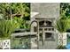 Close up view of outdoor kitchen with granite countertops and pizza oven at 900 W Plant St, Winter Garden, FL 34787